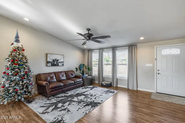 a living room with couches and a flat screen tv