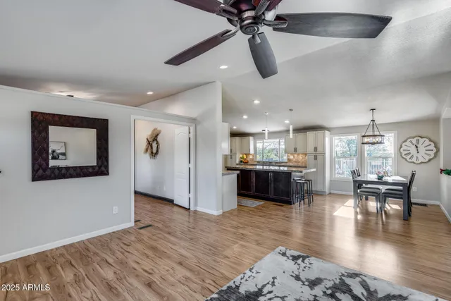 a living room with furniture flowerpot and a chandelier
