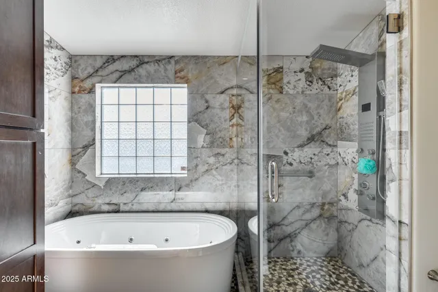 a kitchen with granite countertop a center island and stainless steel appliances