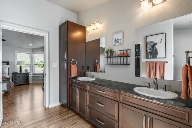 a kitchen with granite countertop kitchen island a sink appliances and a large window