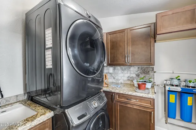 a bathroom with a sink a toilet and shower curtain