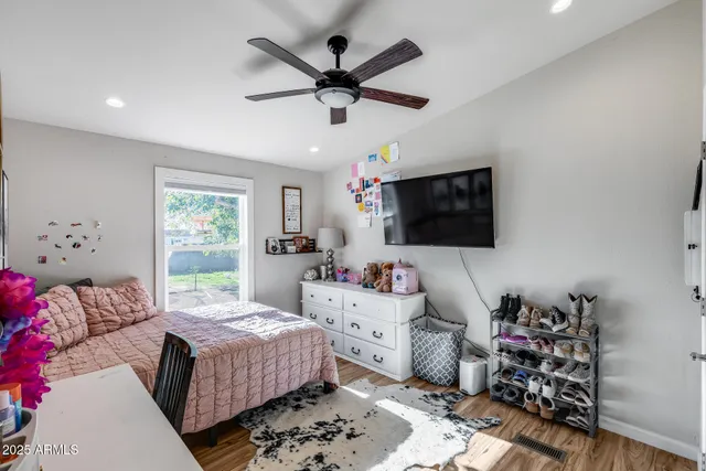 a view of a backyard with couches under an umbrella