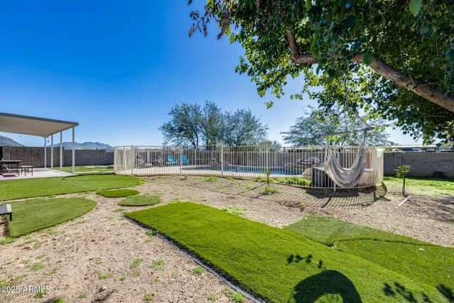 a view of a yard with a house in the background