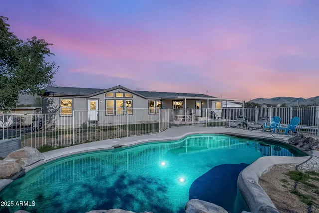 a house with swimming pool in front of it