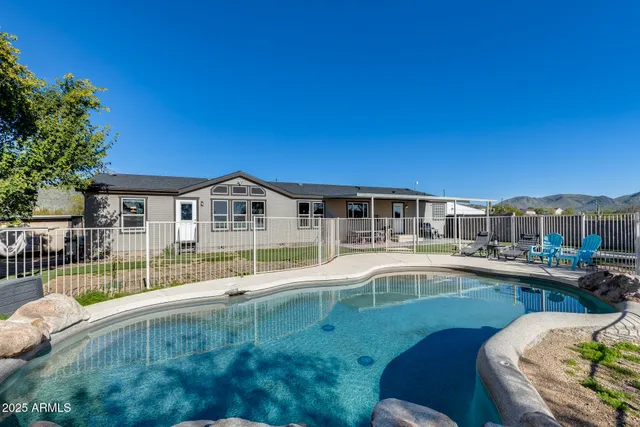 a view of a house with swimming pool and sitting area