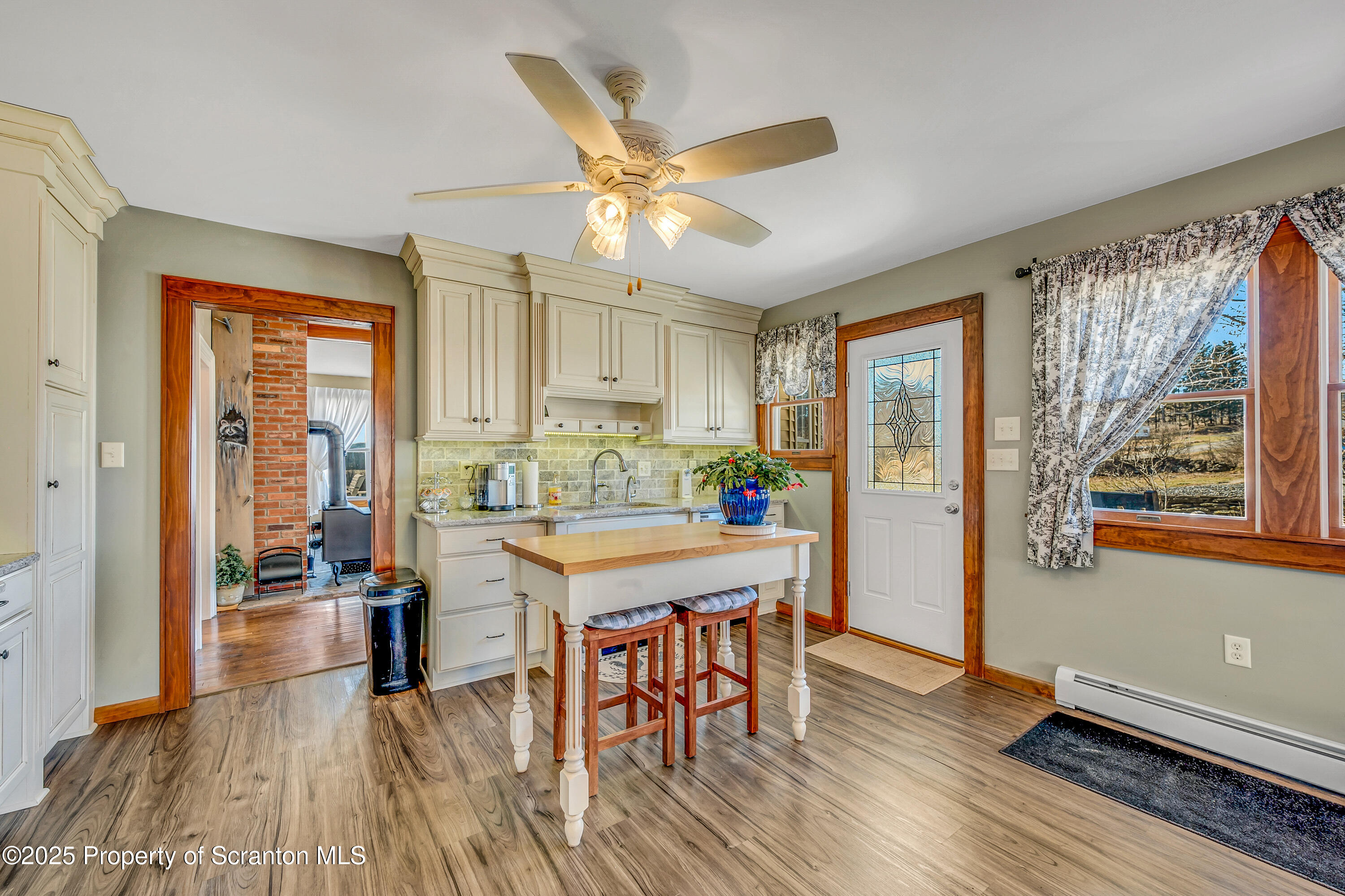 5115 State Rte 3013 Springville, PA 18844 - Photo 35 of 74 a kitchen with stainless steel appliances granite countertop a stove top oven a refrigerator a dining table and chairs with wooden floor