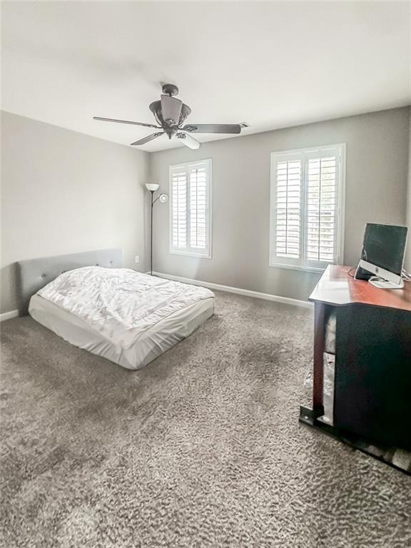 1485 Oglethorpe Run Lane Suwanee, GA 30024 - Photo 15 of 18 a bedroom with a bed and a window