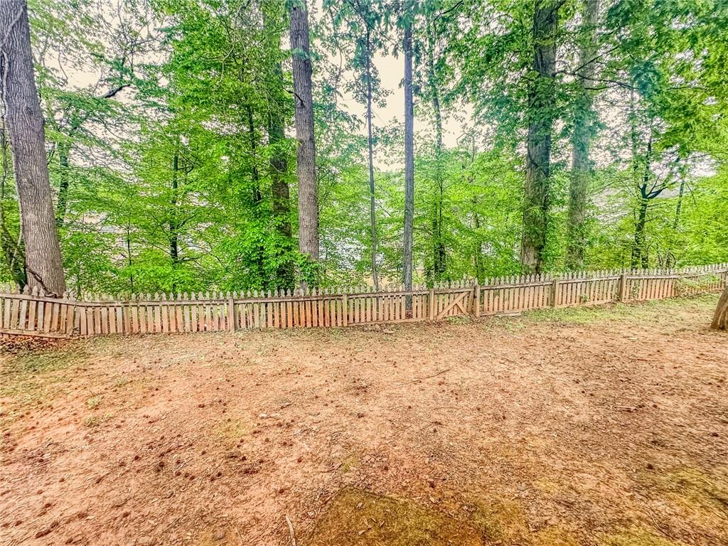 1485 Oglethorpe Run Lane Suwanee, GA 30024 - Photo 18 of 18 a view of a yard with a large trees