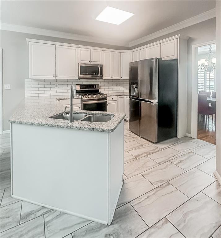 1485 Oglethorpe Run Lane Suwanee, GA 30024 - Photo 3 of 18 a kitchen with stainless steel appliances granite countertop a refrigerator sink and microwave