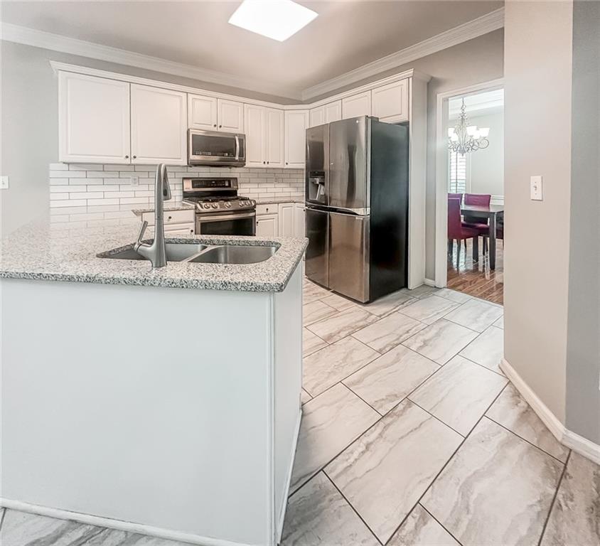 1485 Oglethorpe Run Lane Suwanee, GA 30024 - Photo 4 of 18 a kitchen with stainless steel appliances granite countertop a refrigerator a stove a sink and a granite counter tops