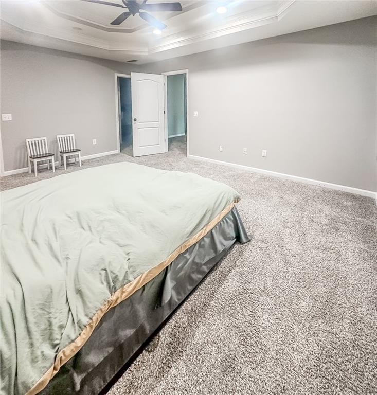 1485 Oglethorpe Run Lane Suwanee, GA 30024 - Photo 10 of 18 a bed sitting in a spacious bedroom next to a window