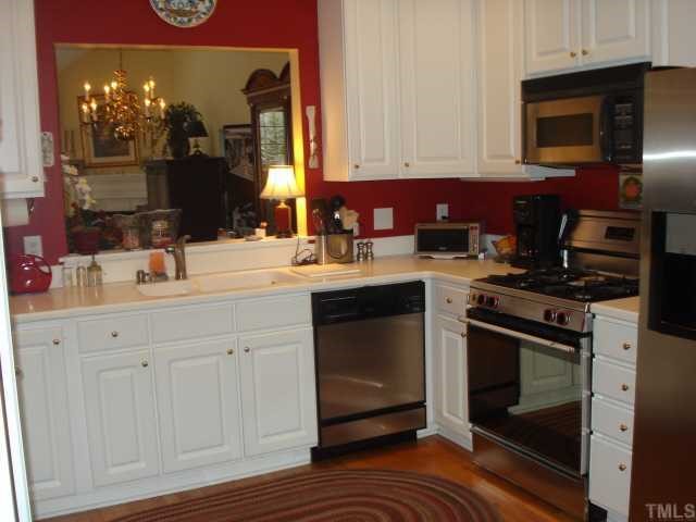 3503 Proprietor Way Raleigh, NC 27612 - Photo 7 of 12 a kitchen with a sink stove and microwave