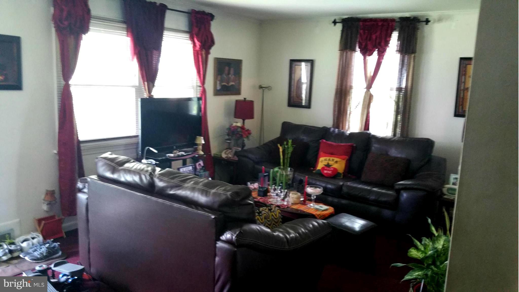 29 Village Road Baltimore, MD 21208 - Photo 3 of 15 a living room with furniture and a flat screen tv