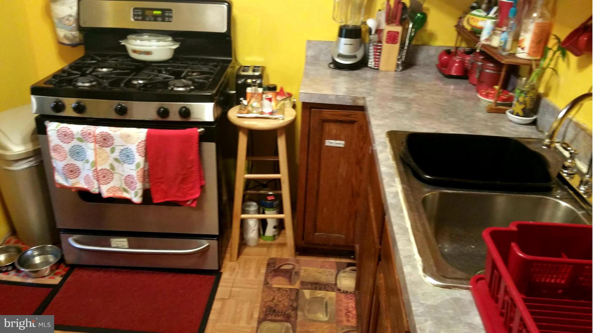 29 Village Road Baltimore, MD 21208 - Photo 6 of 15 a kitchen with a stove and a refrigerator