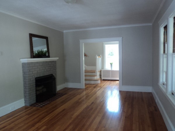 63 Hadwen Road Worcester, MA 01602 - Photo 12 of 29 a view of a hallway with wooden floor and a fireplace