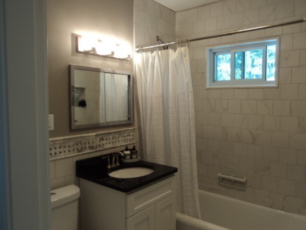 63 Hadwen Road Worcester, MA 01602 - Photo 20 of 29 a bathroom with a granite countertop sink a mirror a shower and a bathtub