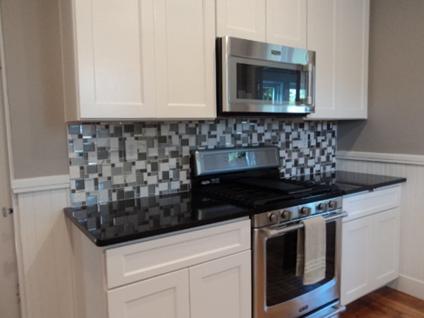 63 Hadwen Road Worcester, MA 01602 - Photo 5 of 29 a kitchen with granite countertop white cabinets and appliances
