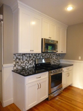 63 Hadwen Road Worcester, MA 01602 - Photo 6 of 29 a kitchen with granite countertop white cabinets and stainless steel appliances
