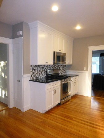 63 Hadwen Road Worcester, MA 01602 - Photo 8 of 29 a kitchen with stainless steel appliances kitchen island granite countertop a stove a sink and a microwave