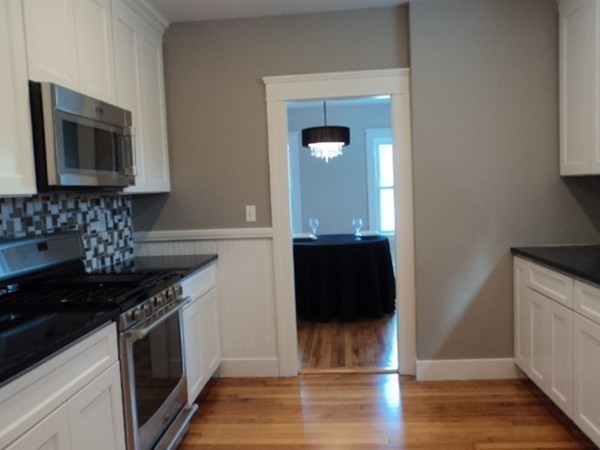 63 Hadwen Road Worcester, MA 01602 - Photo 9 of 29 a kitchen with granite countertop a stove and a microwave