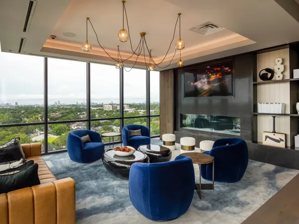 a living room with furniture and a floor to ceiling window