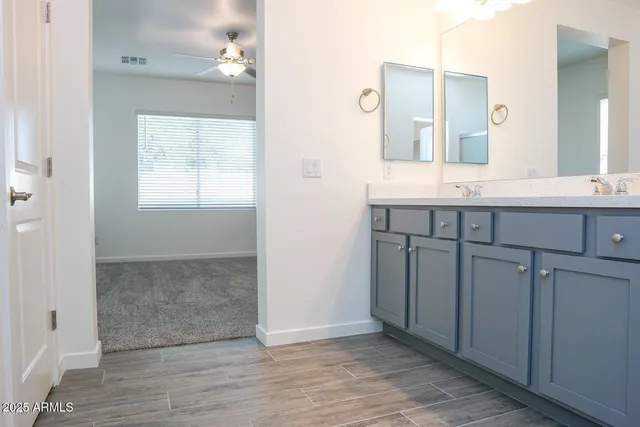 a spacious bathroom with a granite countertop sink and a mirror