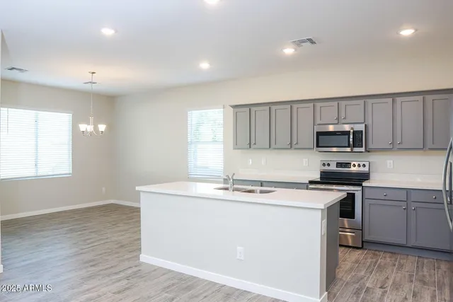 a kitchen with a stove a sink and a microwave