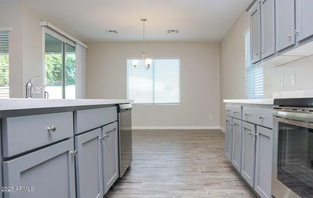 a kitchen with stainless steel appliances granite countertop a sink a stove and a refrigerator