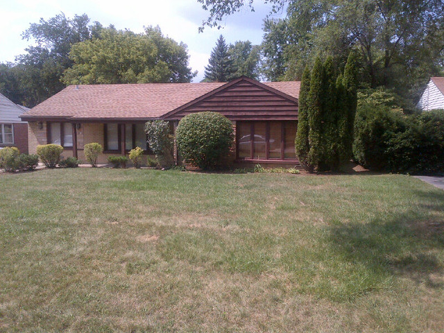 1730 Good Avenue Park Ridge, IL 60068 - Photo 1 of 24 a front view of a house with garden