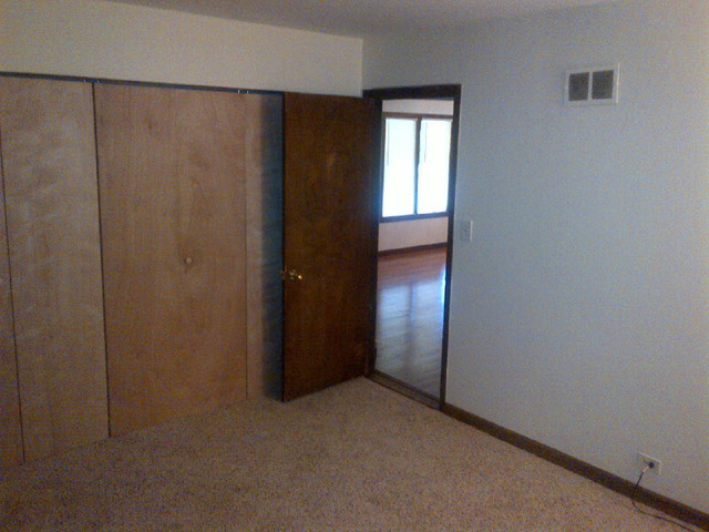 1730 Good Avenue Park Ridge, IL 60068 - Photo 4 of 24 an empty room with windows and closet