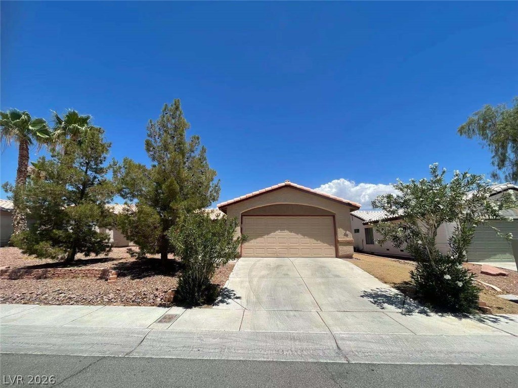 3500 Redwood Ridge Way North Las Vegas, NV 89031 - Photo 2 of 13 A desert-friendly landscape surrounds this single-story residence with an attached garage.