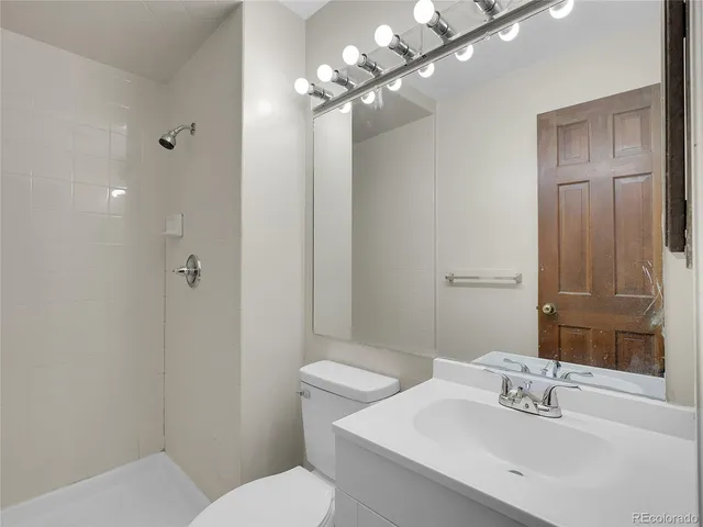 a view of deck with wooden floor and fence with a garden