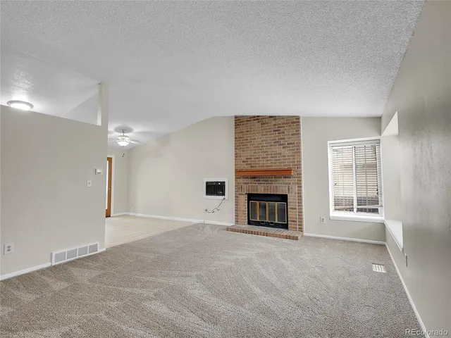 a kitchen with stainless steel appliances granite countertop a refrigerator stove top oven and sink