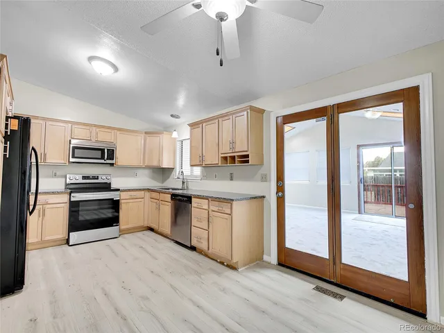 an empty room with windows and cabinet