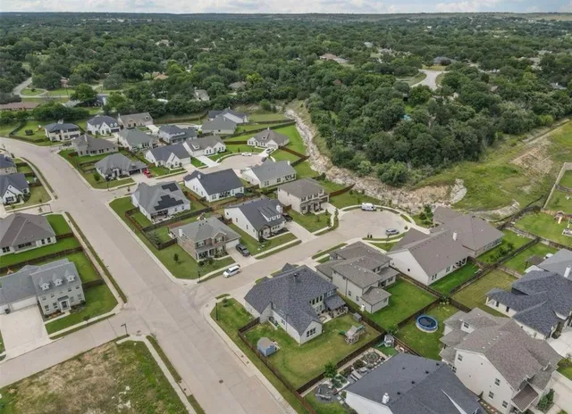 an aerial view of residential houses with outdoor space