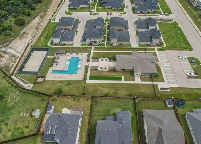 an aerial view of a multi story residential apartment building with yard