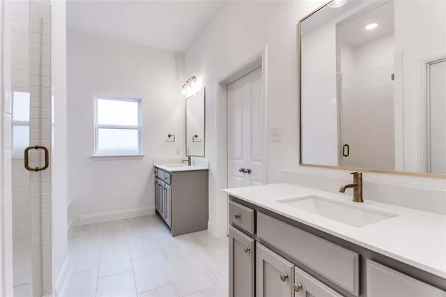 a bathroom with a double vanity sink mirror and