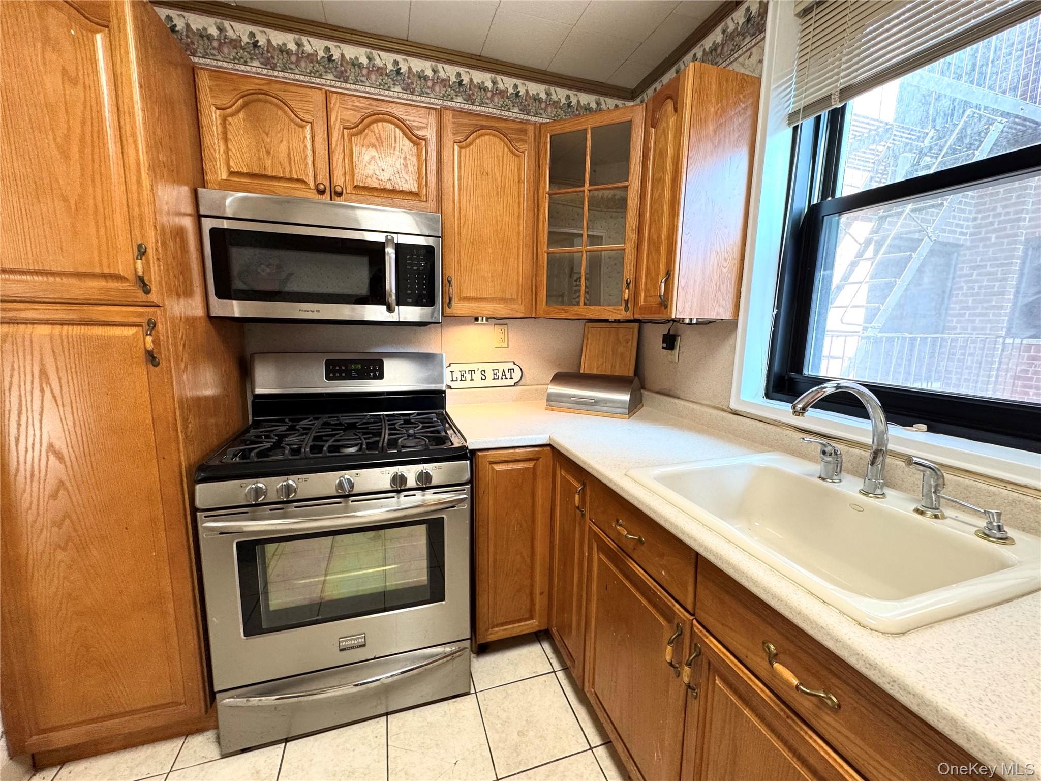 139-15 83rd Avenue, Unit 409 Queens, NY 11435 - Photo 17 of 38 a kitchen with a sink stove and microwave