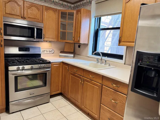 a kitchen with stainless steel appliances granite countertop a stove microwave and sink