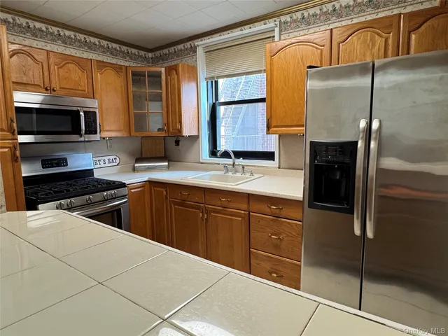 a kitchen with stainless steel appliances granite countertop a refrigerator and a sink
