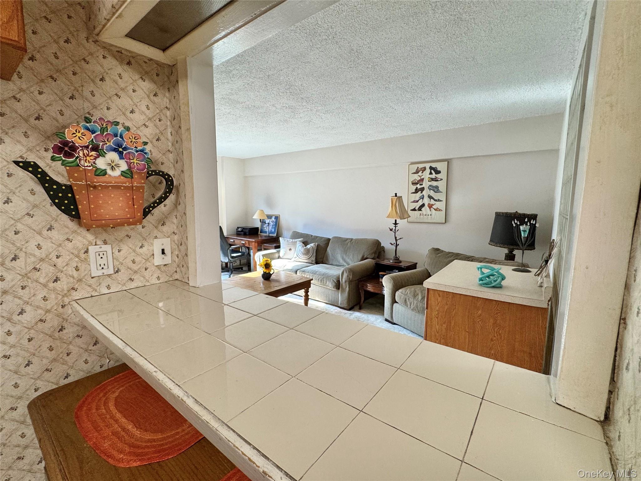 139-15 83rd Avenue, Unit 409 Queens, NY 11435 - Photo 22 of 38 a living room with furniture and a table