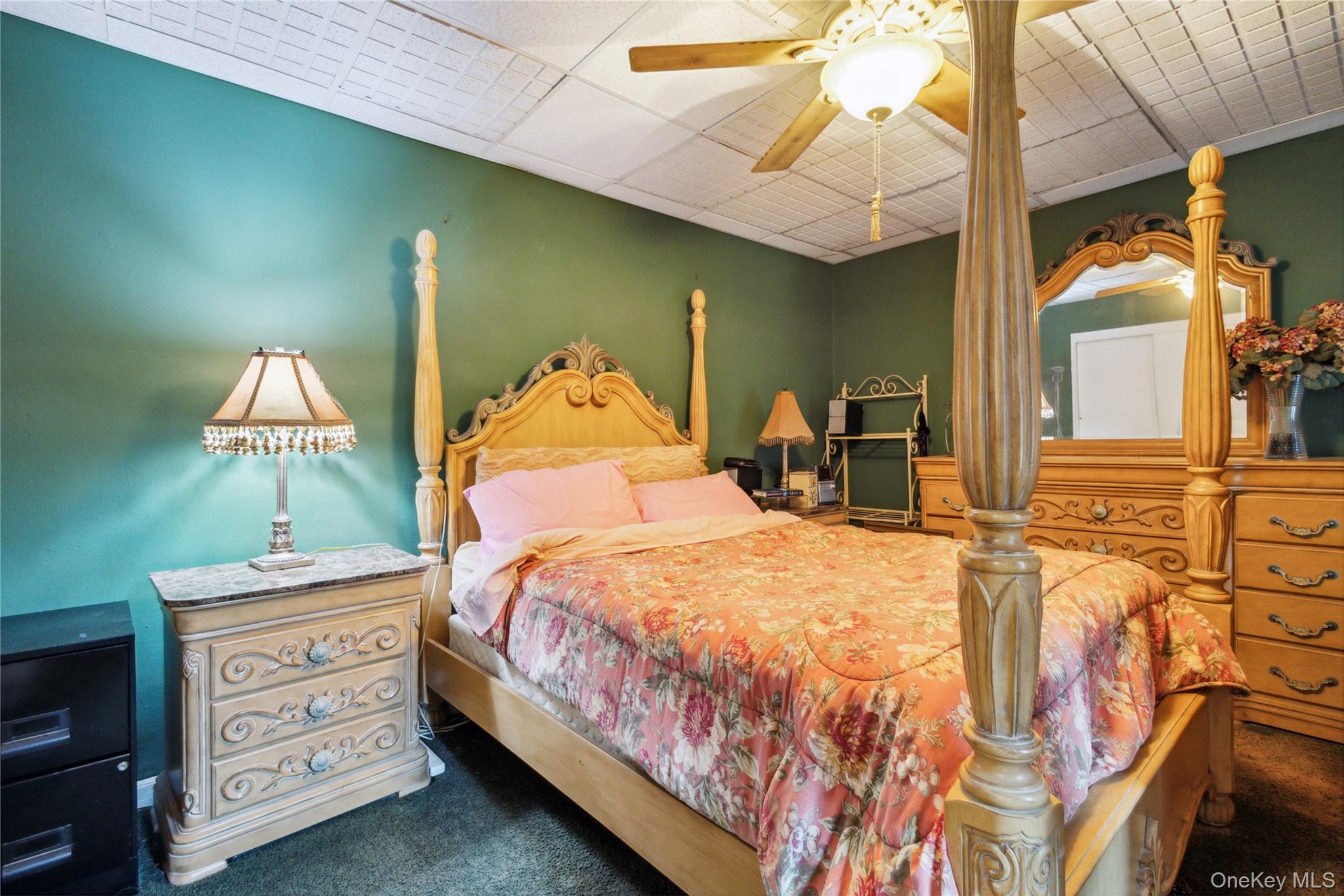 139-15 83rd Avenue, Unit 409 Queens, NY 11435 - Photo 32 of 38 a bedroom with a bed and a chandelier