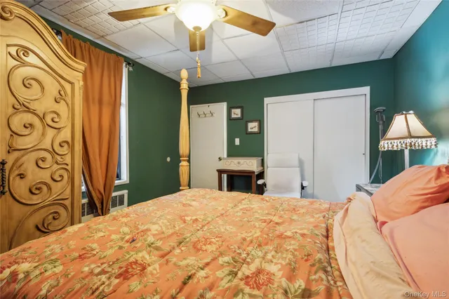 a bedroom with a large bed and a chandelier