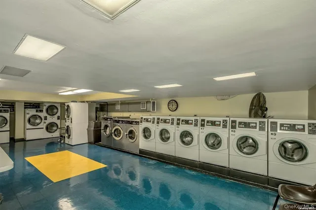 a utility room with stainless steel appliances washer and dryer