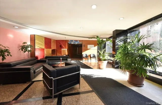 a living room with furniture and a potted plant