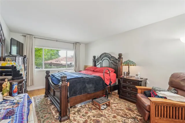 a bedroom with a bed and a window