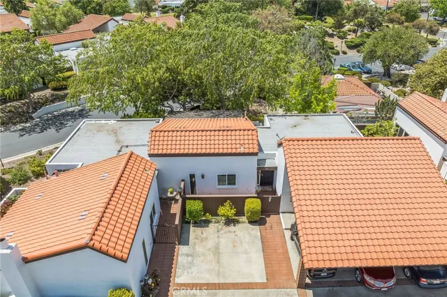 a view of a patio with table and chairs with wooden floor and fence and a barbeque
