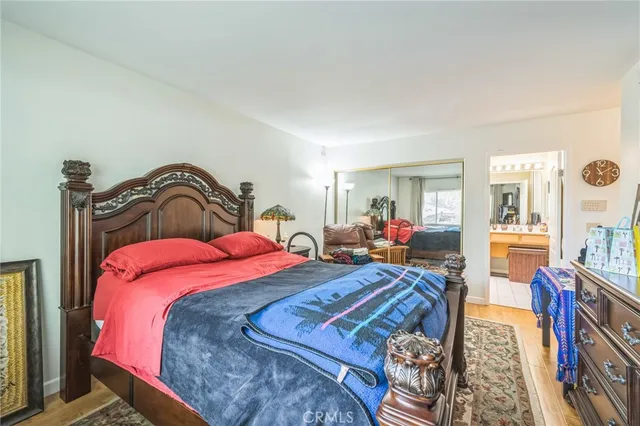 a bedroom with bed and wooden floor