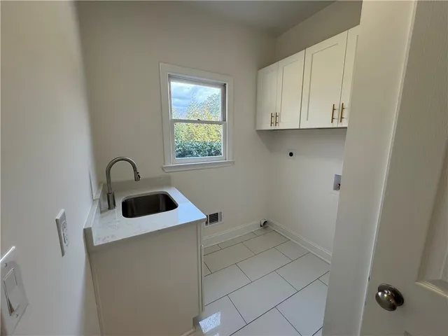 a close view of a sink and dishwasher in a bathroom