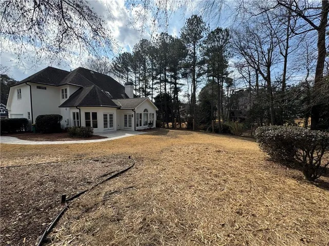 a view of house with yard